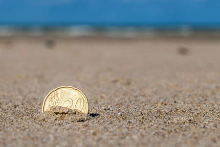 Business coins at holiday in the sand on the beach, North Seaの写真素材