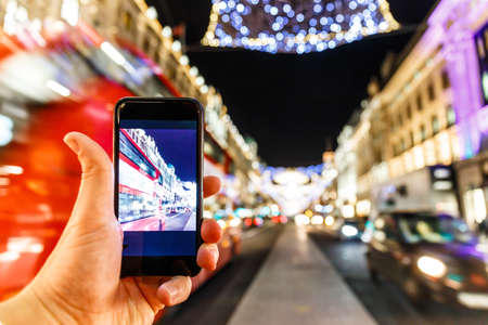 Taking photo of Christmas London on mobile phone, Englandの写真素材