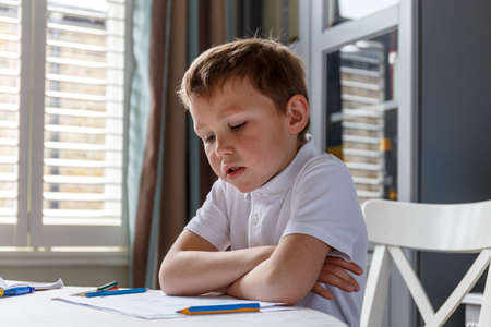 Boy doing his homework and studyingの写真素材