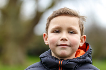 Portrait of school boy in spring park, Londonの写真素材