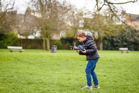 School boy with quadrocopter inthe park, Londonの写真素材