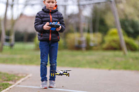 School boy with quadrocopter inthe park, Londonの写真素材