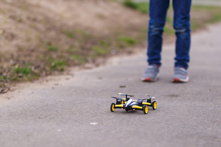 School boy with quadrocopter inthe park, London