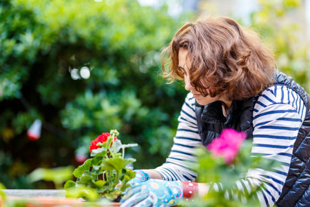 Woman in the back garden planting flowers