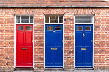 Three doors and brick wall, Englandの写真素材