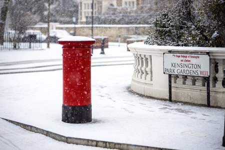 London classic red mailbox  under the falling snow, UKの写真素材
