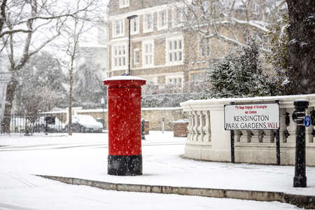 London classic red mailbox  under the falling snow, UKの写真素材