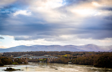 A view of Menai Suspension Bridge, a bridge connecting the island of Anglesey and the mainland of...