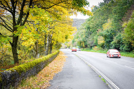 A road in Peak district, an upland area in England at the southern end of the Pennines, UKの写真素材
