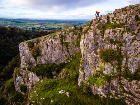 Photographer taking shots of limestone Cheddar Gorge in the Mendip Hills, near the village of Cheddar, Somerset, Englandの写真素材