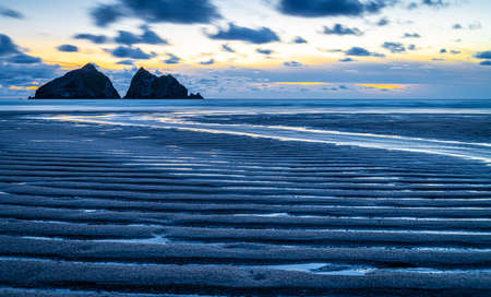 Gull rocks at sunset in Hollywell Bay in Cornwall, UKの写真素材