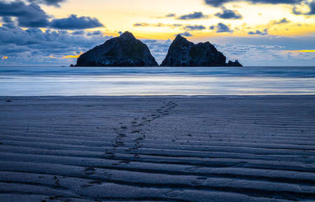 Gull rocks at sunset in Hollywell Bay in Cornwall, UKの写真素材