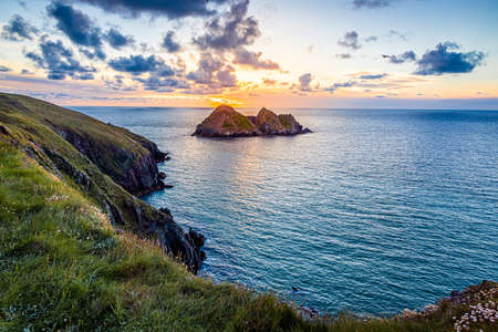 Gull rocks at sunset in Hollywell Bay in Cornwall, UKの写真素材
