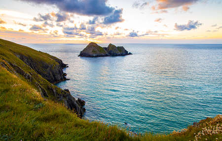 Gull rocks at sunset in Hollywell Bay in Cornwall, UKの写真素材