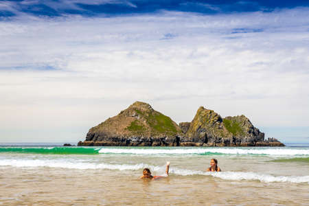 Gull rocks on sunny day in Hollywell Bay in Cornwall, UKの写真素材
