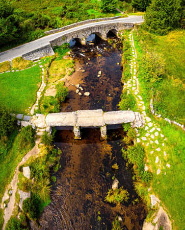 A view of Postbridge Clapper Bridge in Dartmoor National Park is a vast moorland in the county of Devon, in southwest England, UKの写真素材