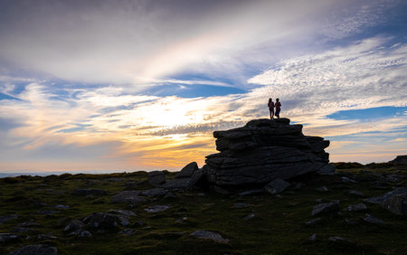 Sunset view of kids in  Dartmoor National Park, a vast moorland in the county of Devon, in southwest England, UKの写真素材