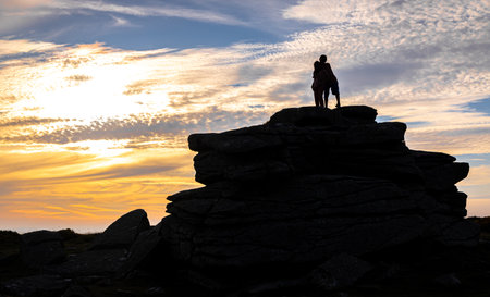 Sunset view of kids in  Dartmoor National Park, a vast moorland in the county of Devon, in southwest England, UKの写真素材