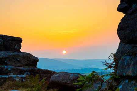 Sunset view of Dartmoor National Park, a vast moorland in the county of Devon, in southwest England, UKの写真素材