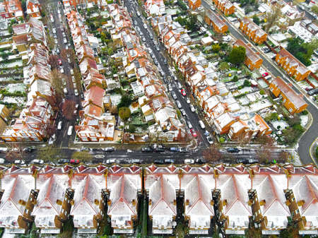 Aerial view of snowy London suburb in winter, UKの写真素材