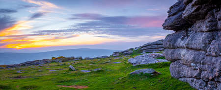 Sunset view of Dartmoor National Park, a vast moorland in the county of Devon, in southwest England, UKの写真素材