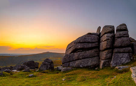 Sunset view of Dartmoor National Park, a vast moorland in the county of Devon, in southwest England, UKの写真素材