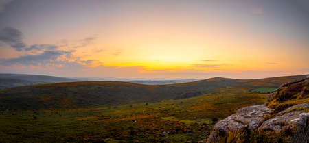 Sunset view of Dartmoor National Park, a vast moorland in the county of Devon, in southwest England, UKの写真素材
