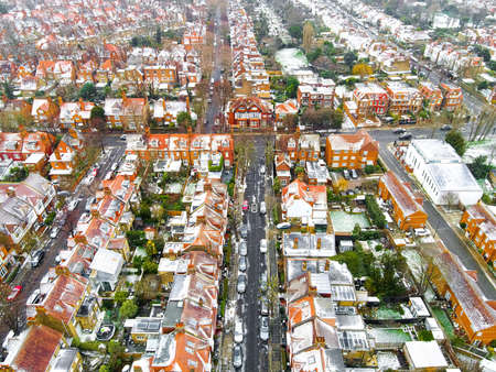 Aerial view of snowy London suburb in winter, UKの写真素材
