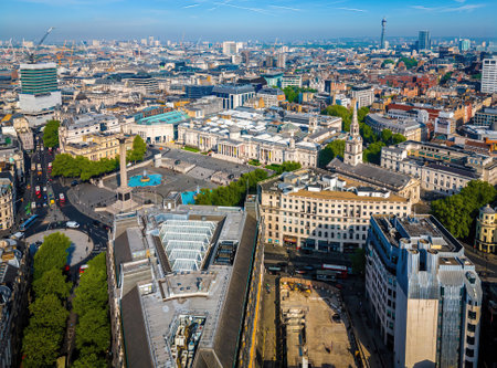 Drone shot of Trafalgar Square in central London, showcasing fountains, monuments, and busy urban surroundings. Ideal for commercial use in tourism, travel, and city landmark promotionの写真素材