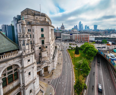 Modern Blackfriars station with solar roof spans River Thames, surrounded by London landmarks including St. Paul's and city skyscrapers; ideal for travel and infrastructure themesの写真素材