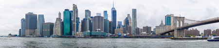 View of Lower Manhattan skyline from the waterfront with boats and docks along the East River. Perfect for travel, tourism, business, real estate, and New York City lifestyle conceptsの写真素材