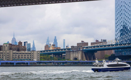 View of Lower Manhattan skyline from the waterfront with boats and docks along the East River....