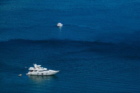 Yachts sail in the calm seaの写真素材