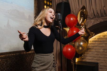A beautiful young girl karaoke song in a nightclub.