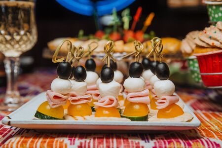 Appetizer of vegetables and ham on a skewer.の写真素材