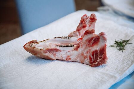 The lower pork jaw lies on a white canvas.の写真素材