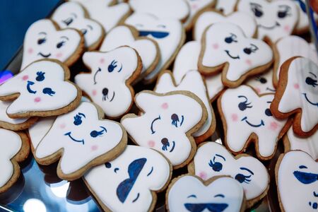 Many different cookies in the form of teeth lie in a rectangular plate .の写真素材