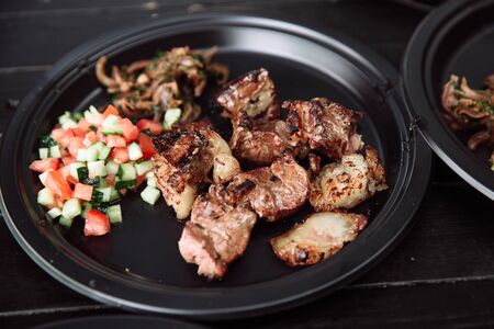 Barbecue meat with onions and tomatoes.の写真素材