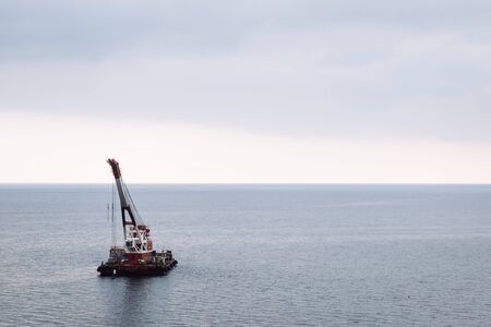 The boat sails on the sea cloudy dayの写真素材