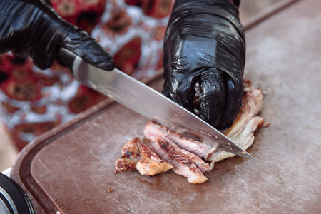Cook is slicing grilled steak.の写真素材