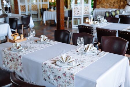 Table setting in the restaurant. A fragment of the interior.の写真素材