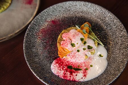 Fresh juicy salmon on a pillow with spicy sauce on a plateの写真素材