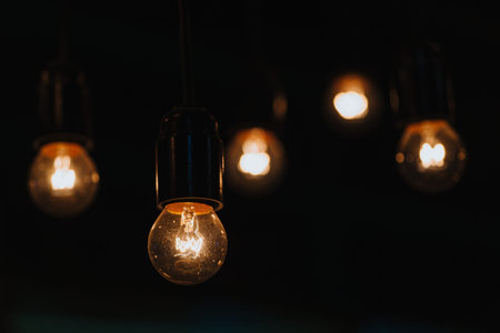 Five pendant burning lights for interior decoration shine in the dark.