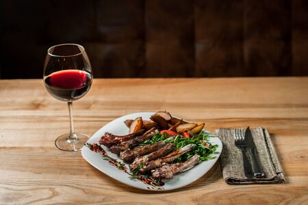 Ribs, cooked grill, with vegetables lie in plate.の写真素材