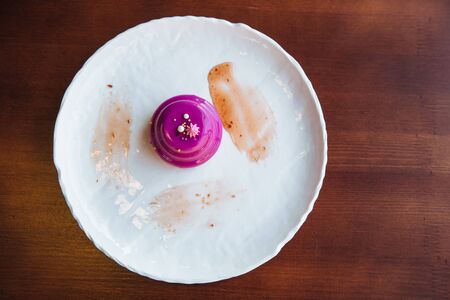 Round cake with walnut filling poured pink glazeの写真素材