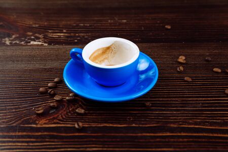 Dirty cup after coffee on a wooden table.の写真素材