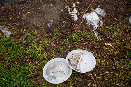 Disposable plastic tableware left in forest long time ago.のeditorial素材
