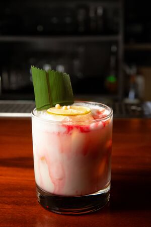 Delicious cocktail with cream in the bar on the wooden counter.の写真素材