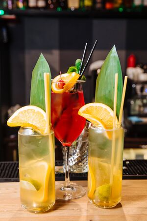  Two glasses of fresh soft drinks from orange and lemon. In a glass of orange and lemon slices, drinking straws. On top of the glass is indicated by a slice of orange.の写真素材