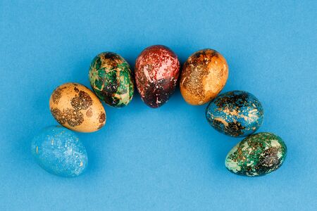 Multi-colored easter eggs are arranged in a semicircleの写真素材